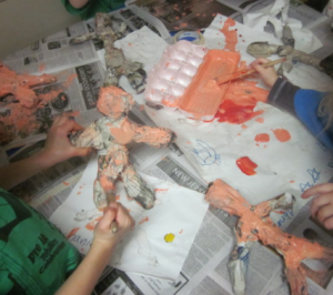 painting their paper mache sculptures